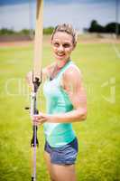 Portrait of female athlete practicing archery