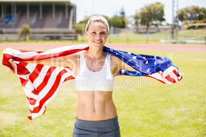 Portrait of female athlete wrapped in american flag