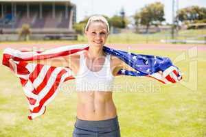 Portrait of female athlete wrapped in american flag