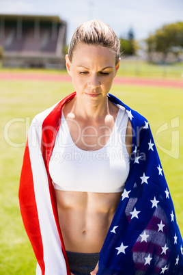 Female athlete wrapped in american flag