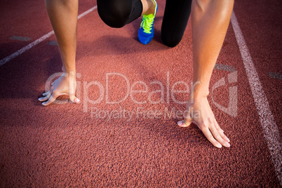 Female athlete in ready to run position