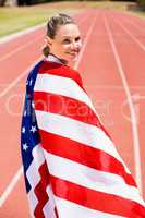 Portrait of female athlete wrapped in american flag