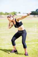 Female athlete preparing to throw shot put ball