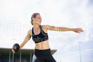 Female athlete about to throw a discus