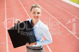 Portrait of happy businesswoman with briefcase