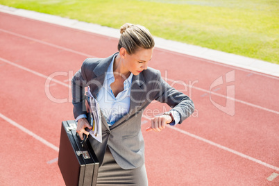 Businesswoman with briefcase in ready to run position