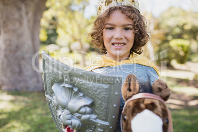 Cute boy standing and pretending to be a knight