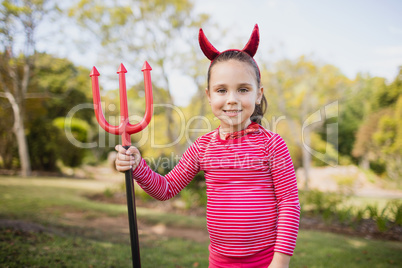 Little girl pretending to be a devil