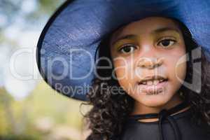 Portrait of cute girl dressing up as witch