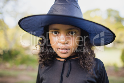 Portrait of cute girl dressing up as witch