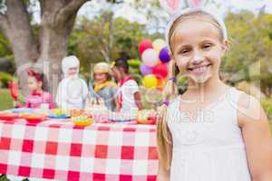 Smiling girl wearing a costume during a birthday party