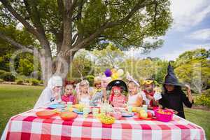 Children wearing costume having fun during birthday party