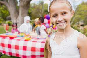 Smiling girl wearing a costume during a birthday party
