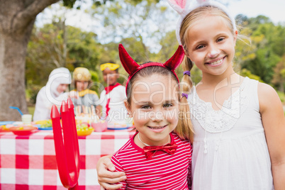 Smiling girls wearing costume during a birthday party