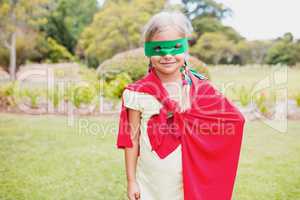 Little girl wearing superhero costume