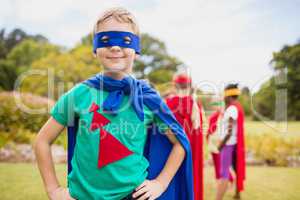 Little boy wearing superhero costume posing for camera