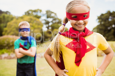 Children wearing superhero costume posing for camera