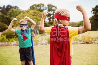 Children wearing superhero costume posing for camera