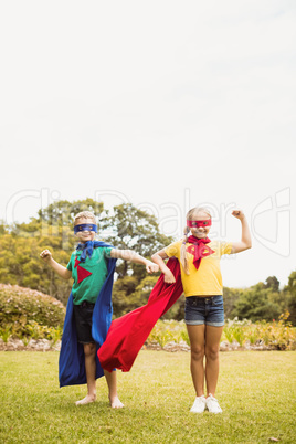 Facing view of children wearing superhero costume posing for camera