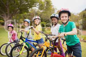 Smiling children posing with bikes