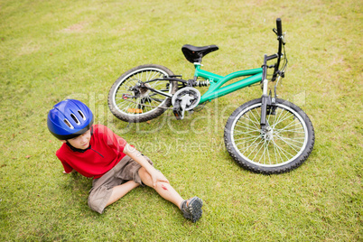 Sad child falling from his bike