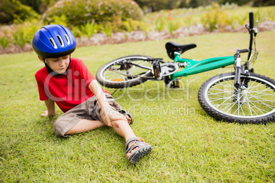 Sad child falling from his bike