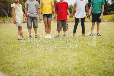 Cropped image of children holding hands