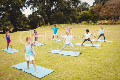 Side view of children doing yoga