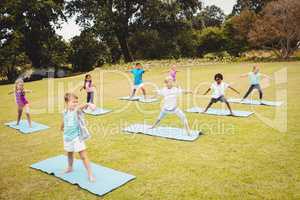 Side view of children doing yoga