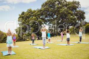 Children standing and doing yoga