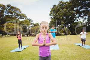 Close up view of girl doing yoga with friends