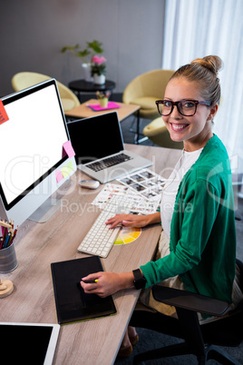 Casual businesswoman using a graphic tablet