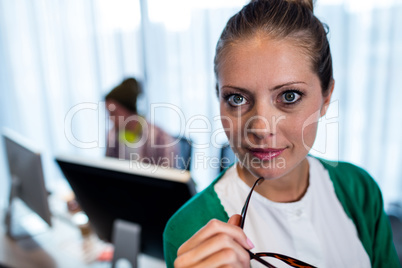 Businesswoman posing front of her coworker