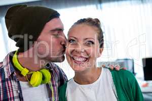 Man worker kissing his colleague