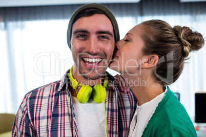 Woman worker kissing her colleague