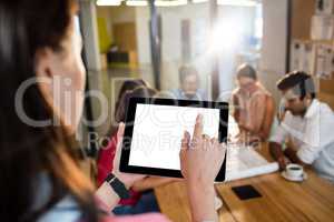 Casual businesswoman using a tablet