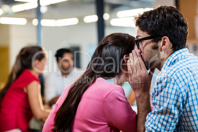 Casual colleagues whispering