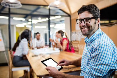 Casual businessman using a tablet