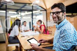 Casual businessman using a tablet