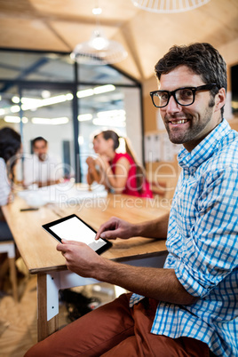 Casual businessman using a tablet