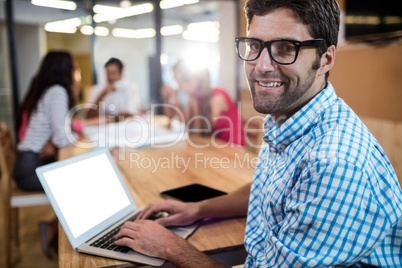 Casual businessman using a laptop