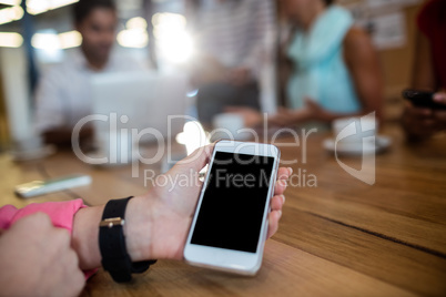 Casual businesswoman holding smartphone