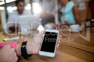 Casual businesswoman holding smartphone