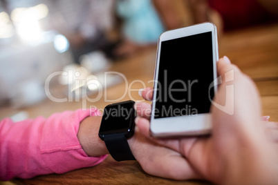 Woman with smartphone and smart watch