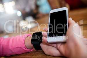 Woman with smartphone and smart watch