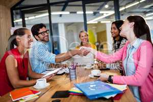 Casual business team giving handshake