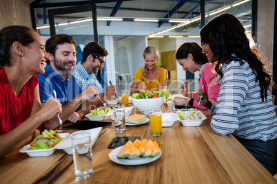 Casual business team eating together