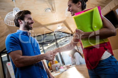 Casual business people shaking their hands