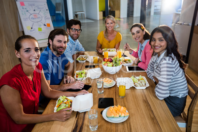 Casual business team eating together