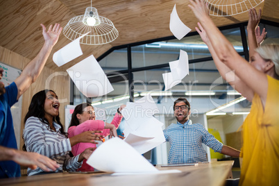 Casual colleagues throwing paper